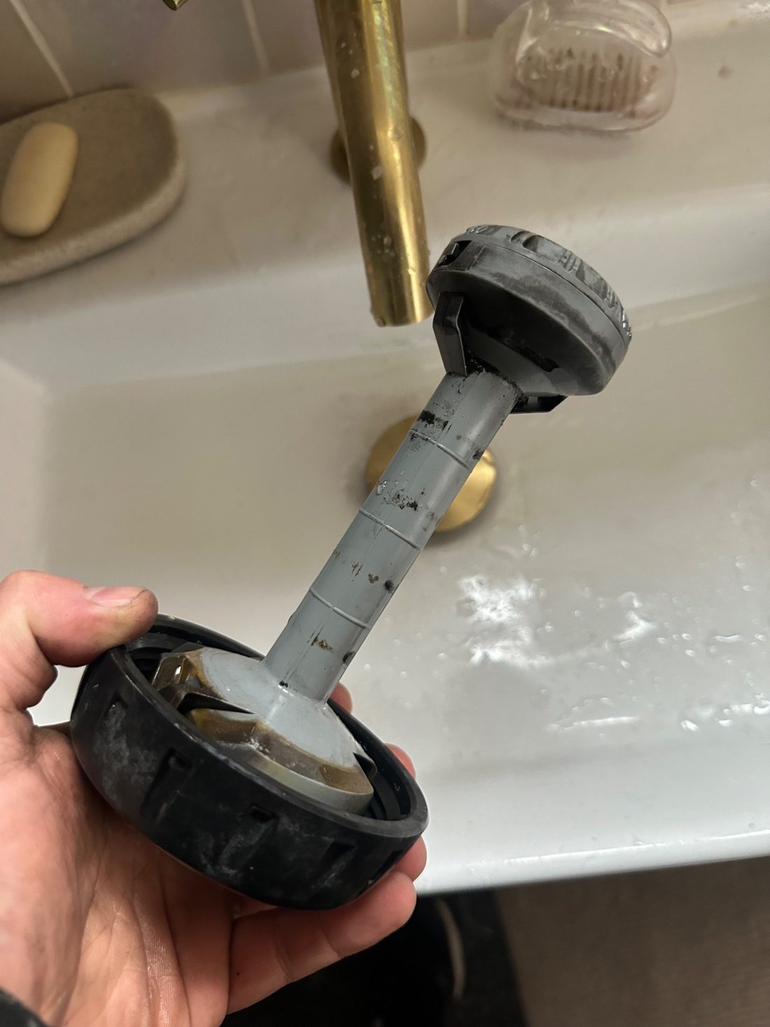The same magnetic filter cleaned and ready to be refitted, showing the magnet rod and housing free of sludge